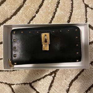 Marc Jacobs wallet with gold hardware.
